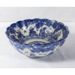 A Chinese blue and white bowl decorated with figures and trees