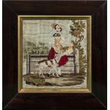 A 19th century framed wool embroidery of a girl with a dog