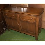 An Ercol oak sideboard.