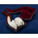 An antique Meerschaum pipe with amber tip depicting Sherlock Holmes in fitted case