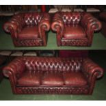 A three piece red leather Chesterfield suite