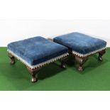 A pair of small upholstered foot stools