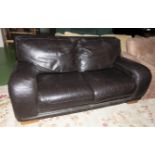 A brown leather two seater sofa