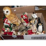 A box containing Christmas items and pottery animals