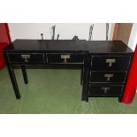 An ebonised side table and drawers