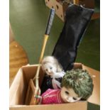 A box containing dolls and a racquet