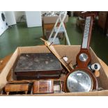 A box containing wooden items and a barometer