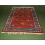 A red ground wool rug