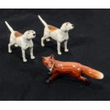 A Beswick fox and two Beswick foxhounds