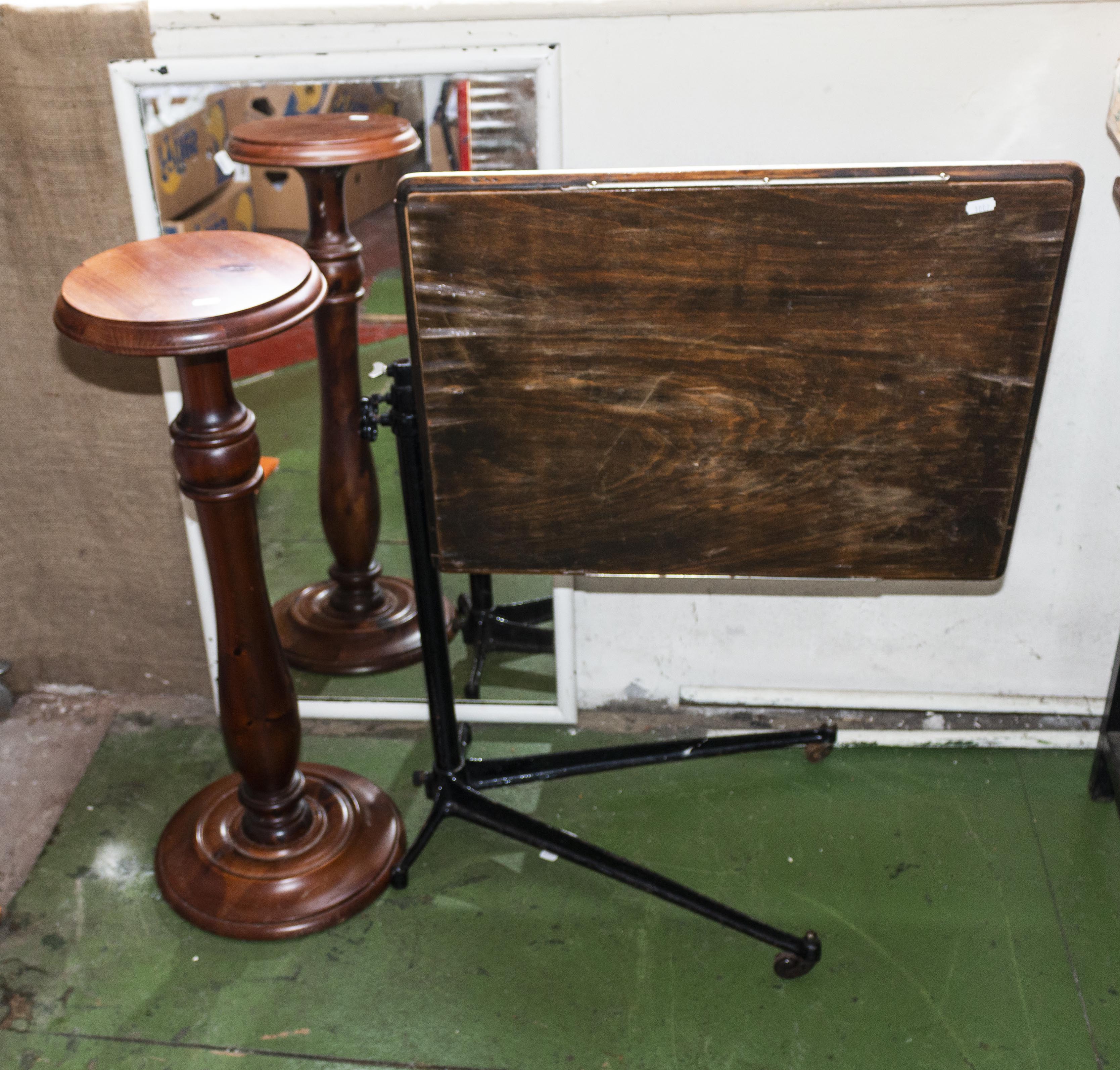 A plant stand, mirror and a bedside table