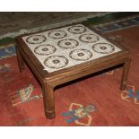 A tiled top teak coffee table