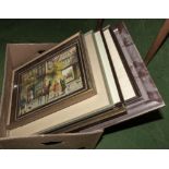 A box of framed prints