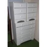 A white chest of drawers and two bedside drawers