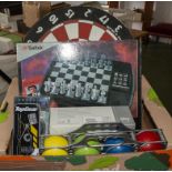 A chess set, dart board and a set of boules