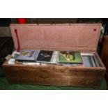 A pine box containing a large quantity of records