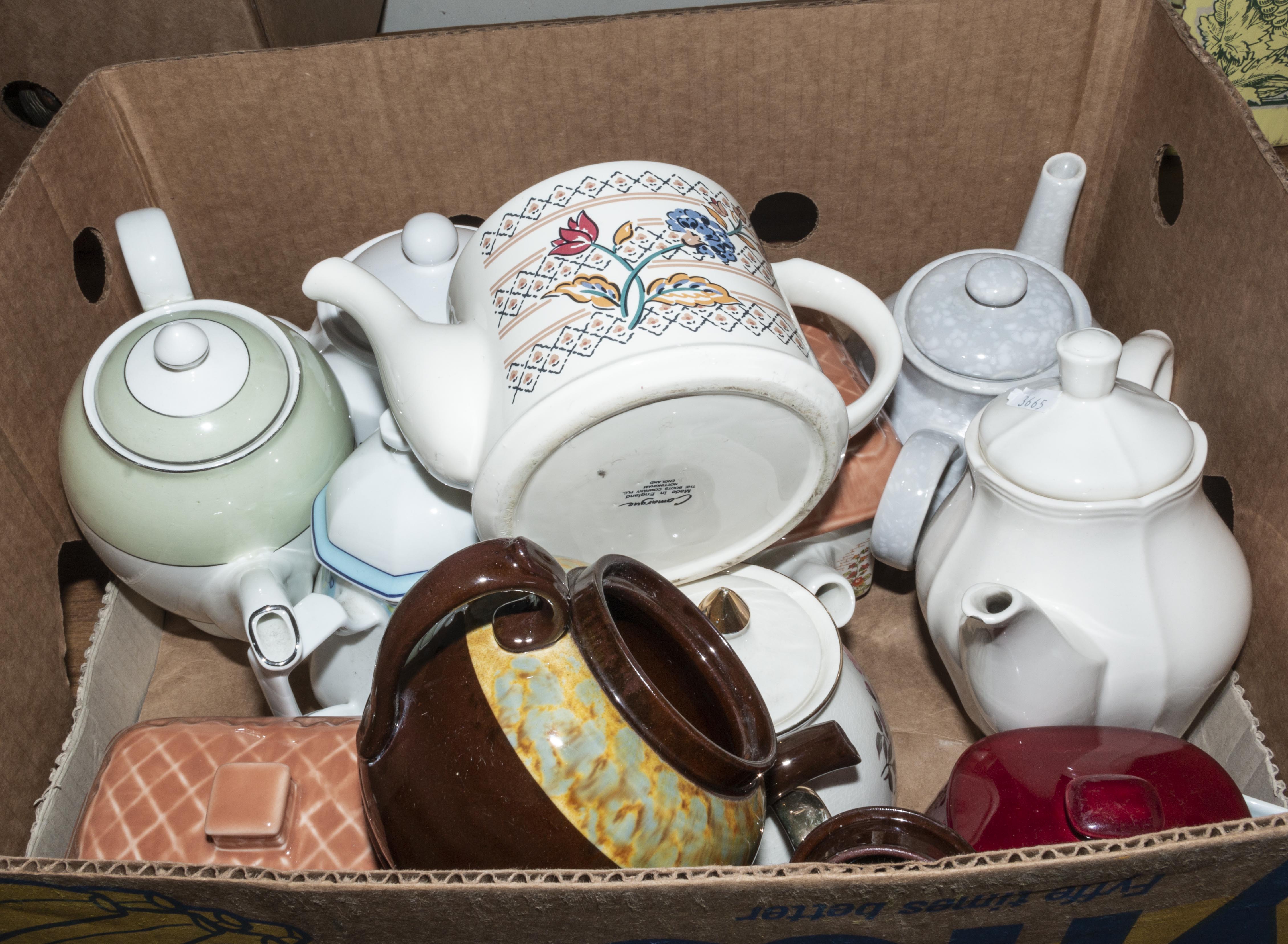 A box containing pottery teapots