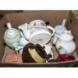 A box containing pottery teapots