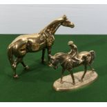 A brass horse and a horse and jockey