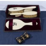 A lady's vintage brush set and a pair of opera glasses