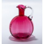 A Victorian cranberry glass decanter.