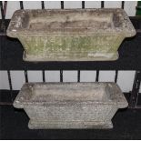 A pair of reconstituted stone plant troughs.