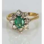 An 18ct gold emerald and diamond cluster ring (approx 1ct)