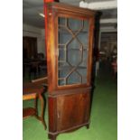 An Edwardian inlaid mahogany free standing corner cabinet.