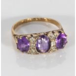 An 18ct gold three stone amethyst and diamond ring (4gms)
