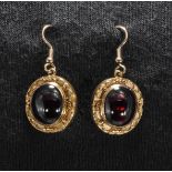 A pair of 9ct gold oval garnet earrings
