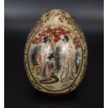 A Japanese hand painted egg, signed