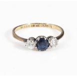 An 18ct gold ring set with a sapphire and two diamonds