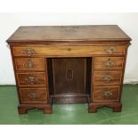 A Georgian mahogany and satinwood kneehole desk with fitted top drawer