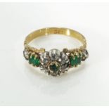 An 18ct gold emerald and diamond cluster ring