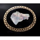 A large 9ct gold horse head opal and onyx brooch