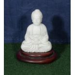 A small jade Buddha and stand