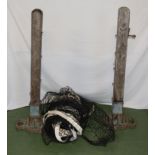 A Victorian tennis court net with oak stands and a pair of iron bases.