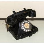 A vintage bakelite telephone.