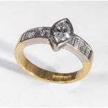 An 18ct yellow and white gold 65pt marquise cut diamond ring with baguette cut diamond shoulders