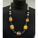 A vintage African necklace of assorted beads including horn and malachite