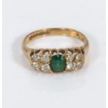 An 18ct gold emerald and diamond ring (50pt diamonds)
