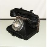 A vintage bakelite telephone.