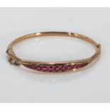 A 9ct gold bangle set with ruby's and diamonds (5gms)