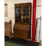 An inlaid mahogany bureau bookcase with leaded glass doors.