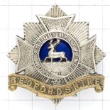Bedfordshire Regiment pre 1919 Officer’s silver, gilt and blue enamel cap badge.