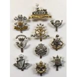 10 assorted early anodised cap badges.