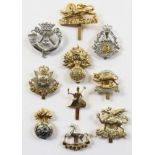 10 early anodised cap badges.