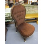 A Victorian walnut spoon back chair with a carved crest, raised on cabriole forelegs