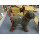 A Push-along soft toy dog on wheels