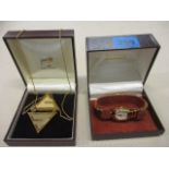 A 1977 Givenchy fashion necklace, boxed, together with a Gucci horseshoe design ladies wristwatch,