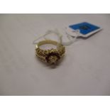 A 14ct gold dress ring with yellow shank and raised shoulders and head, each shoulder set with eight